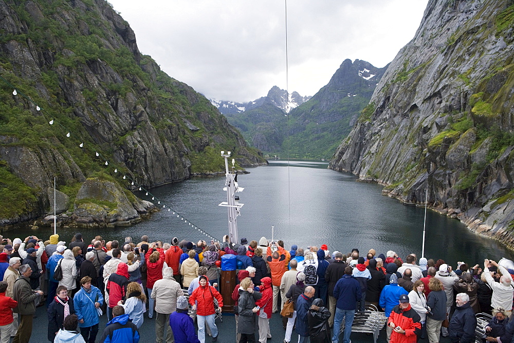 Passengers aboard Cruiseship MS Astor admire narrow Fjord, Trollfjord, Finnmark, Norway, Europe