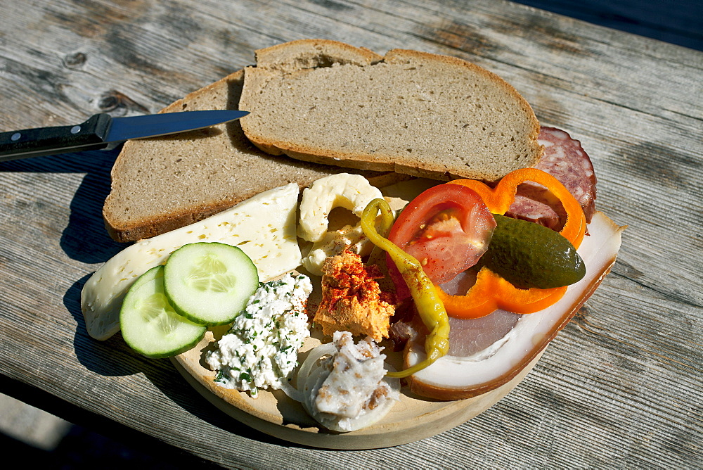 Typical snack of assorted cheese, ham, salami and bread, Loosegg Alm, Salzburger Land, Austria