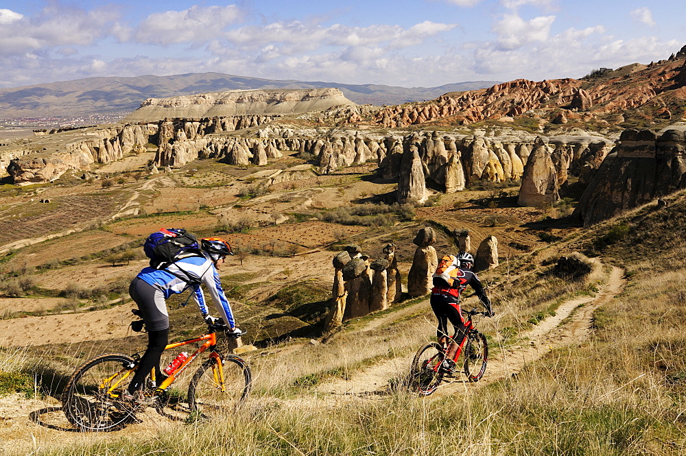 Mountain bikers near Cavusim, Goereme valley, Goereme, Cappadocia, Turkey