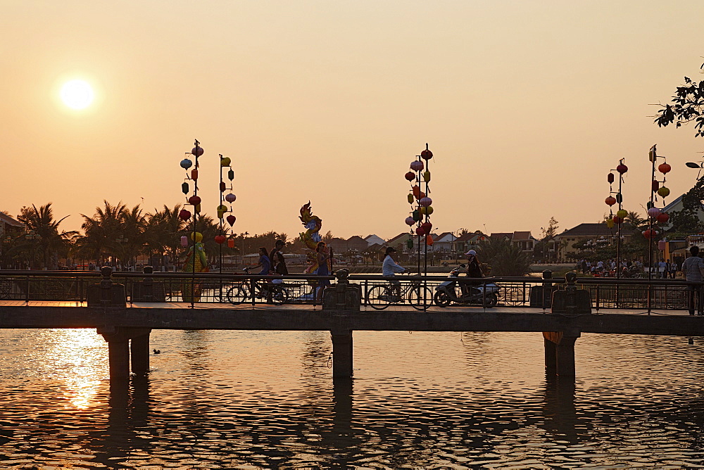 People passing bridge in the evening, Hoi An, Annam, Vietnam