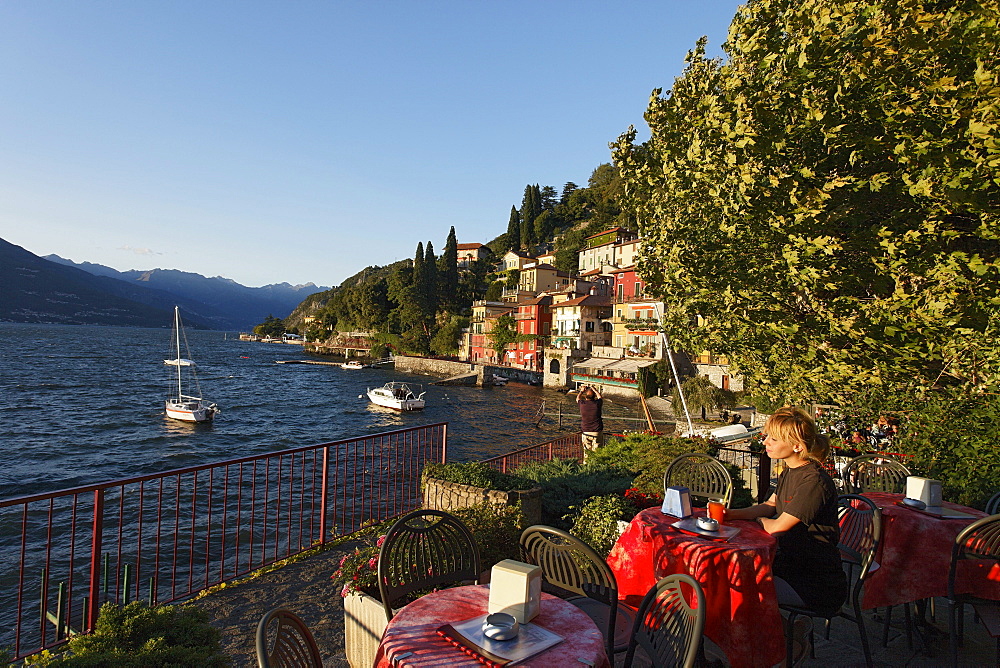 Woman drinking juice, Varenna, Lake Como, Lombardy, Italy