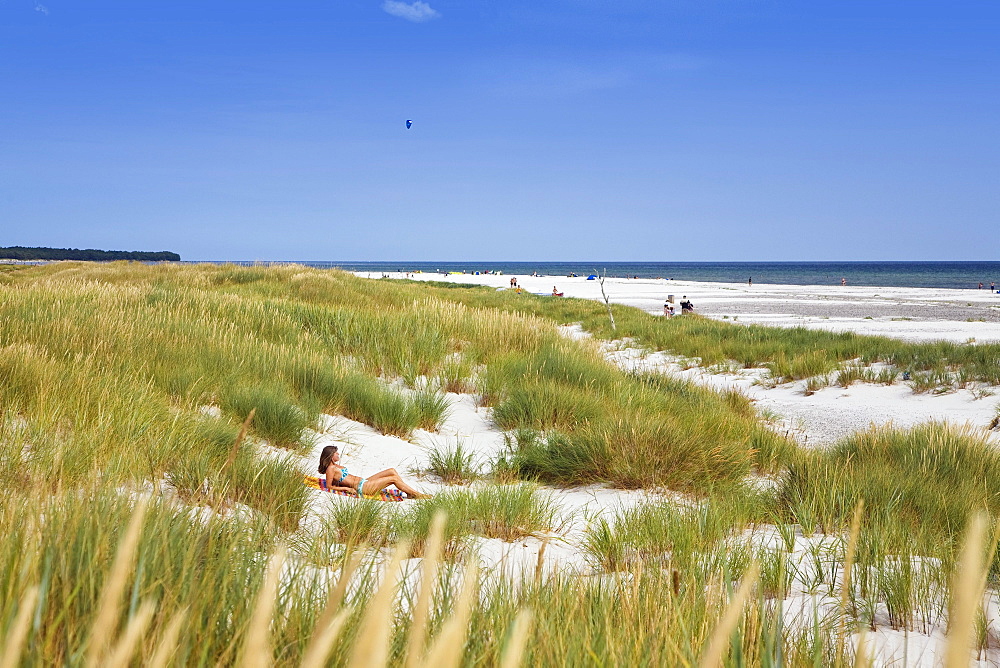 Woman, 40 years old, sunbathing in the dunes at Dueodde beach, Bornholm, Denmark, Europe