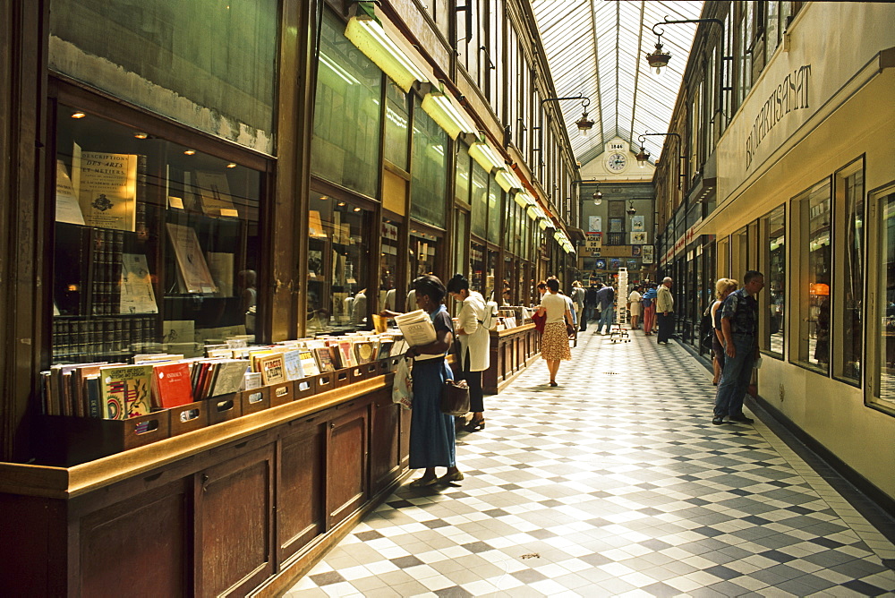 People in front of a second hand bookshop at Passage Jouffroy, 9. Arrondissement, Paris, France, Europe