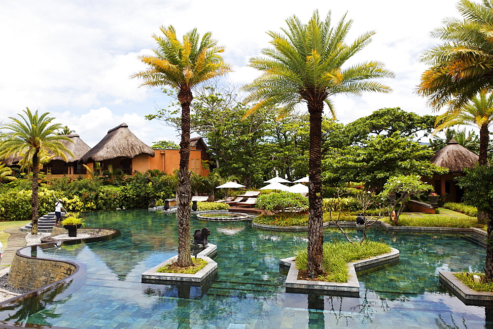 Pool of the Shanti Maurice Resort under clouded sky, Souillac, Mauritius, Africa