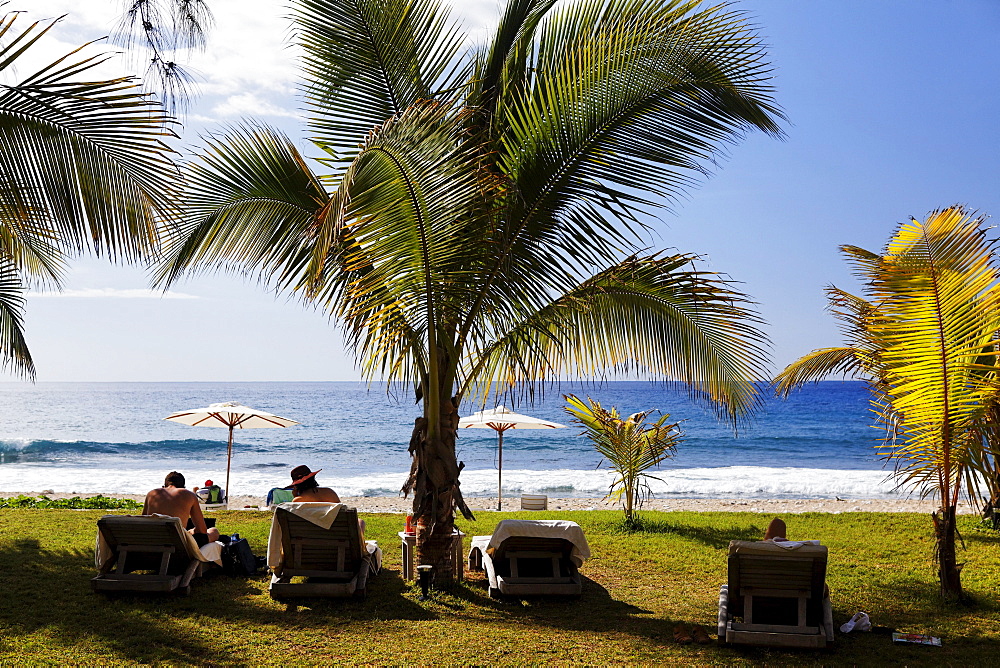 People and palm trees on the beach at Hotel Saint Alexis, Saint Gilles les Bains, La Reunion, Indian Ocean