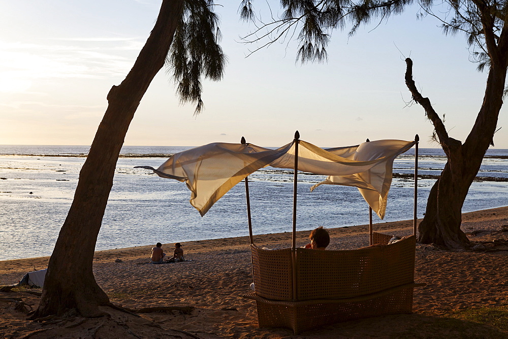 Beach chair on the beach of Grand Hotel du Lagoon at sunset, Saint Gilles, La Reunion, Indian Ocean