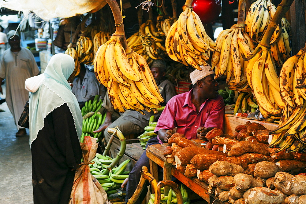 People at fruit stand at Darajani Market, Stonetown, Zanzibar City, Zanzibar, Tanzania, Africa