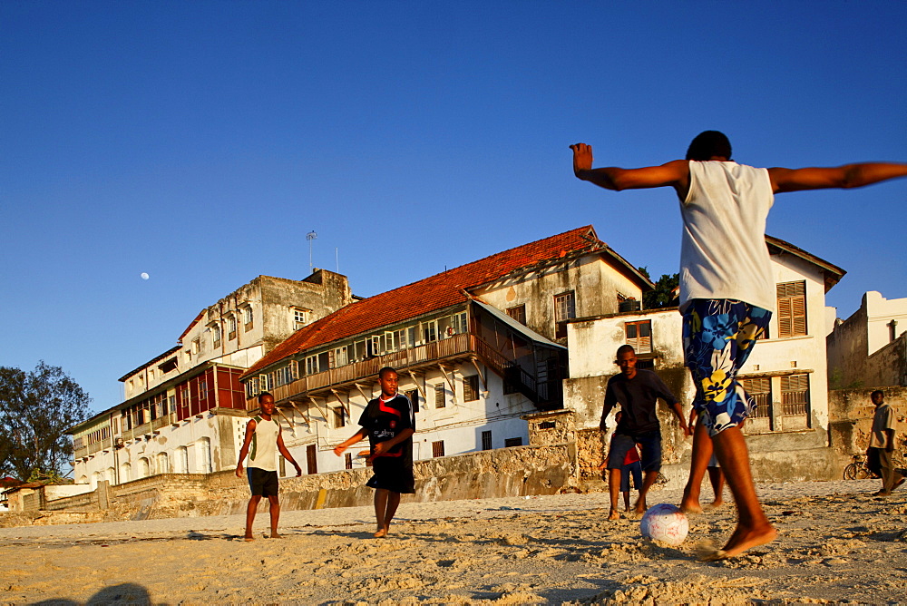 Children playing soccer on the beach of Stonetown, Zanzibar City, Zanzibar, Tanzania, Africa