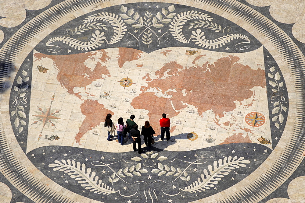 People looking at world map on the ground in front of Monument of the Discoveries, Lisbon, Portugal, Europe