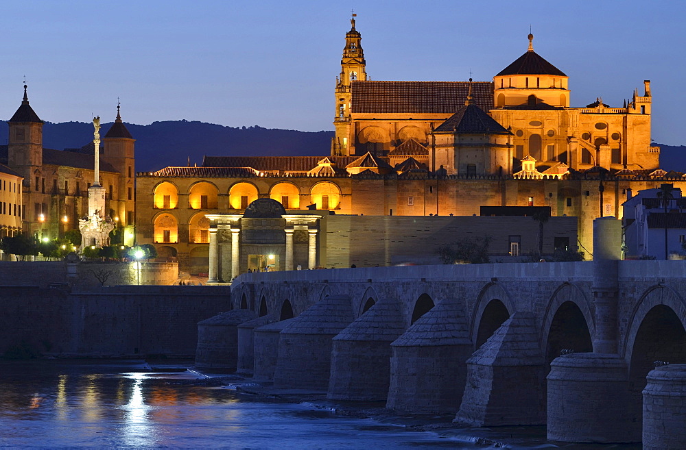 Illuminated cathedral La Mezquita, roman bridge and the river Guadalquivir in the evening, Cordoba, Andalusia, Spain, Europe