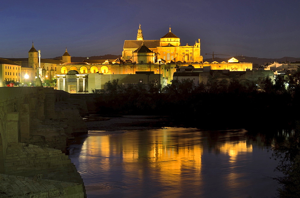 Illuminated cathedral La Mezquita, roman bridge and the river Guadalquivir in the evening, Cordoba, Andalusia, Spain, Europe