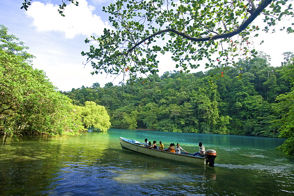 Jamaica Port Antonio Tropical landscape at Blue lagoon, tour boat with tourists