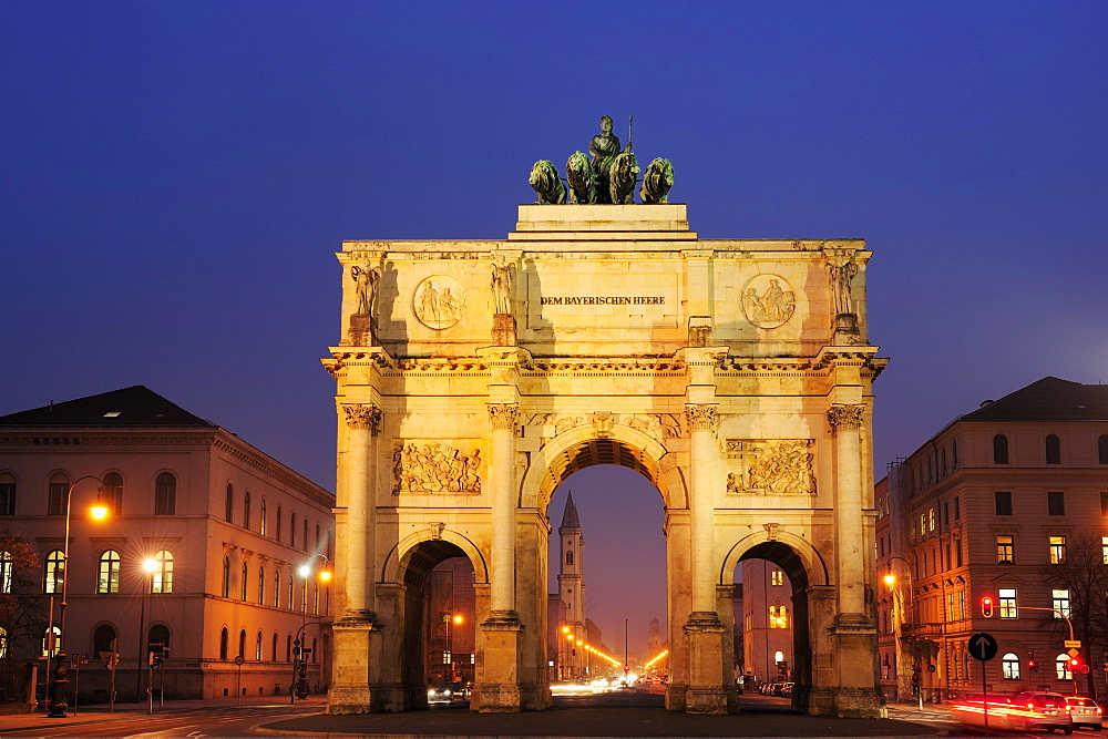 Illuminated Siegestor gate with Ludwigstrasse and Ludwigskirche in the background, Munich, Upper Bavaria, Bavaria, Germany, Europe