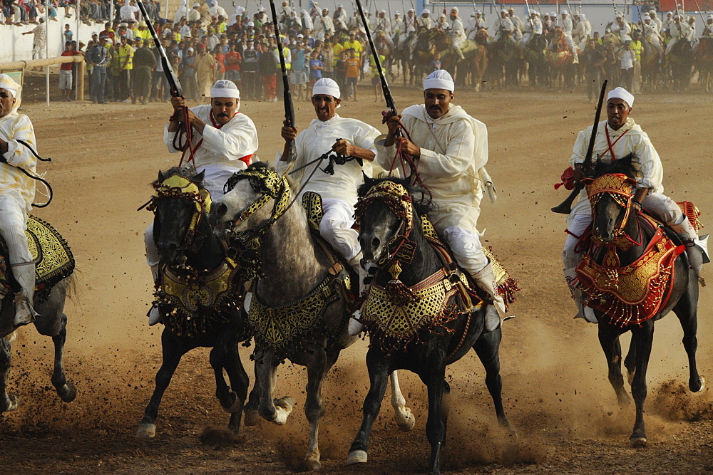 Men on horseback carrying guns, Fantasia festival for the Moussem of Moulay Abdallah near el-Jadida, Atlantic Coast, Morocco, Africa