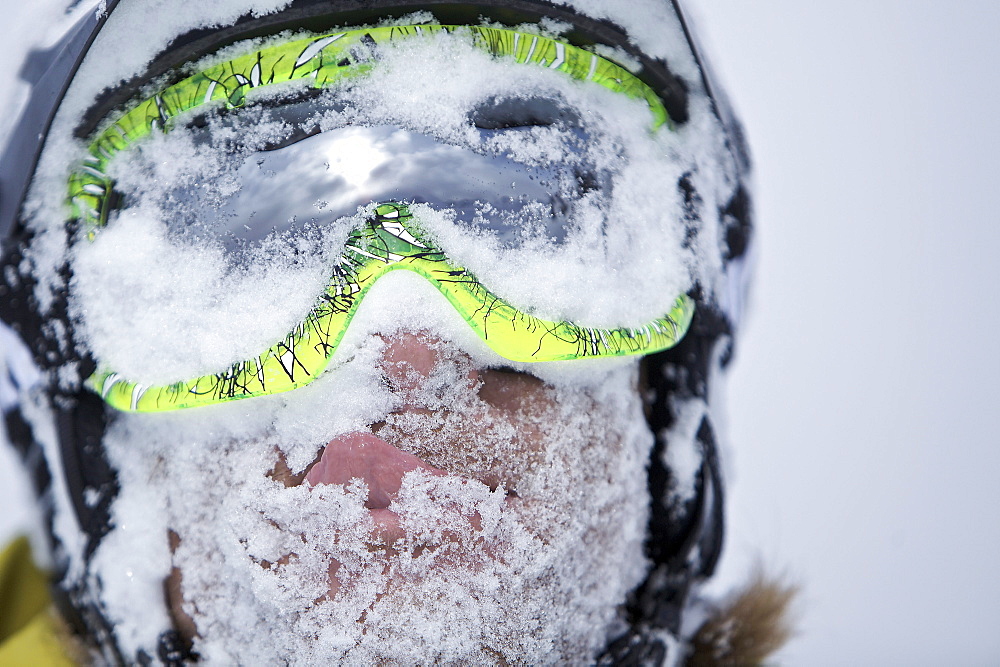 Snow-covered face of a snowboarder, Chandolin, Anniviers, Valais, Switzerland