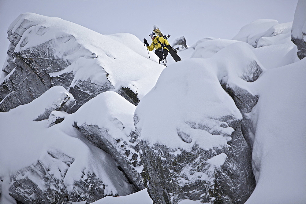 Snowboarder ascending in deep snow, Chandolin, Anniviers, Valais, Switzerland