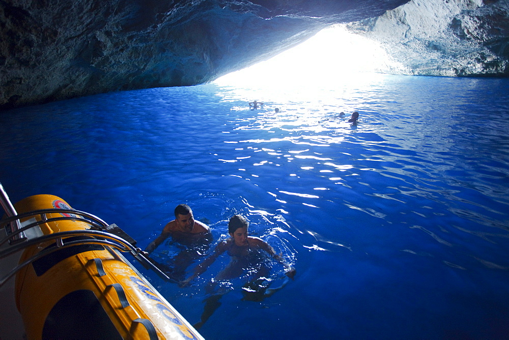 People swimming in the Blue Grotto, Cabrera island, Balearic Islands, Spain, Europe