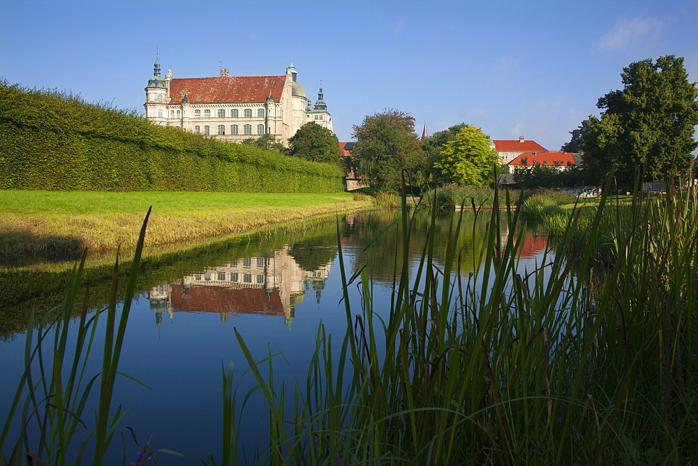 Reflection of Renaissance castle in a canal, Guestrow, Mecklenburg switzerland, Mecklenburg Western-Pomerania, Germany, Europe