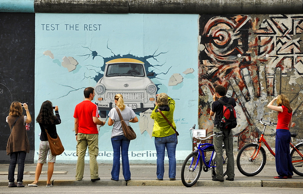 People in front of paintings of the East Side Gallery, Berliner Mauer, Muehlenstrasse, Berlin, Germany, Europe