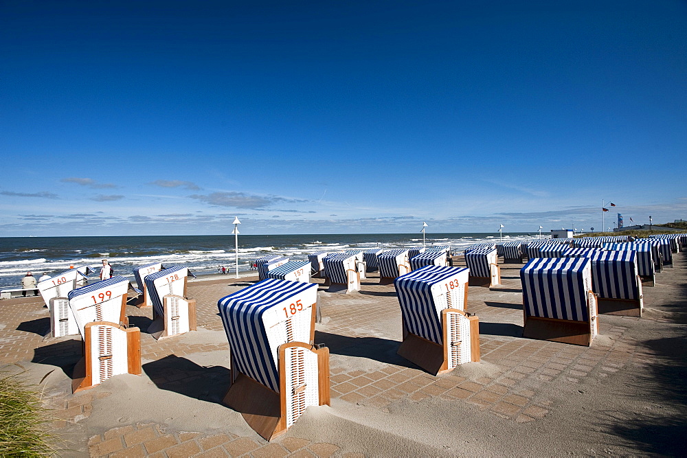 Roofed wicker beach chairs at promenade, Norderney, East Frisian Islands, Lower Saxony, Germany