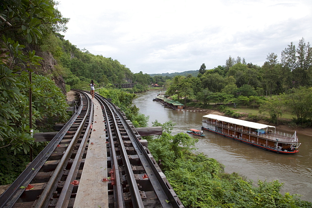 Wooden trestle viaduct of Trans River Kwai Death Railway at Saphan Tham Krasae with river cruise ship RV River Kwai (Cruise Asia Ltd.) on River Kwai Noi, near Kanchanaburi, Thailand