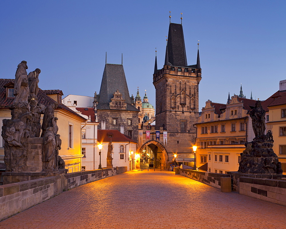 Charles bridge and city gate in the evening, Prague, Czechia, Europe