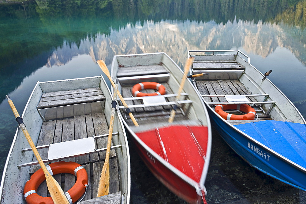 Rowing boats at the banks of Laghi di Fusine, Julian Alps, Italy, Europe