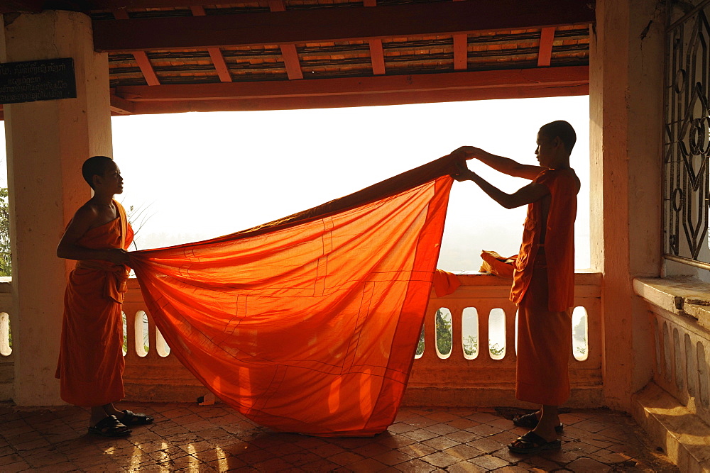 Buddhist monks, novices, cladding their robes, Phu Si hill, Luang Prabang, Laos