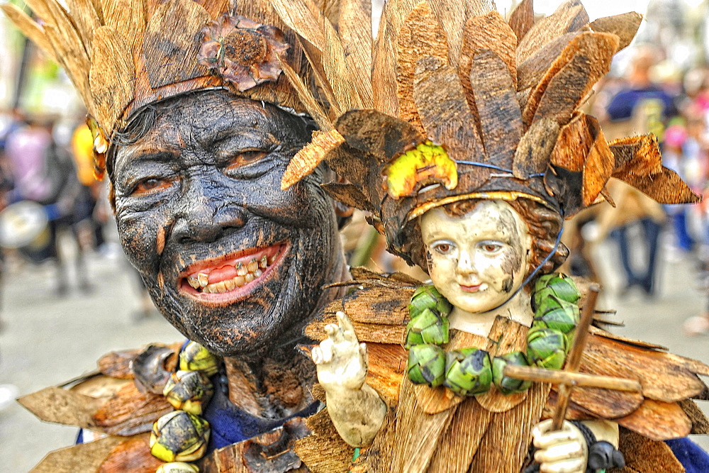 Toothless man holding a holy Santo Nino doll, Ati Atihan festival, Kalibo, Aklan, Panay Island, Visayas, Philippines