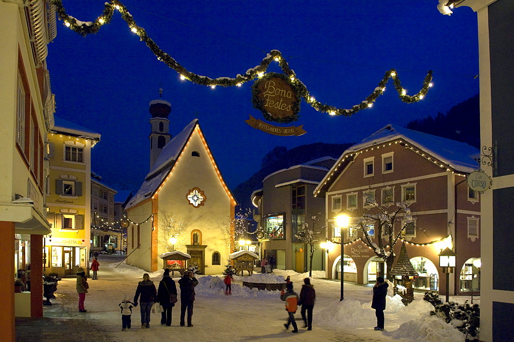 People in snowy street in the evening, Ortisei, Val Gardena, South Tyrol, Italy, Europe