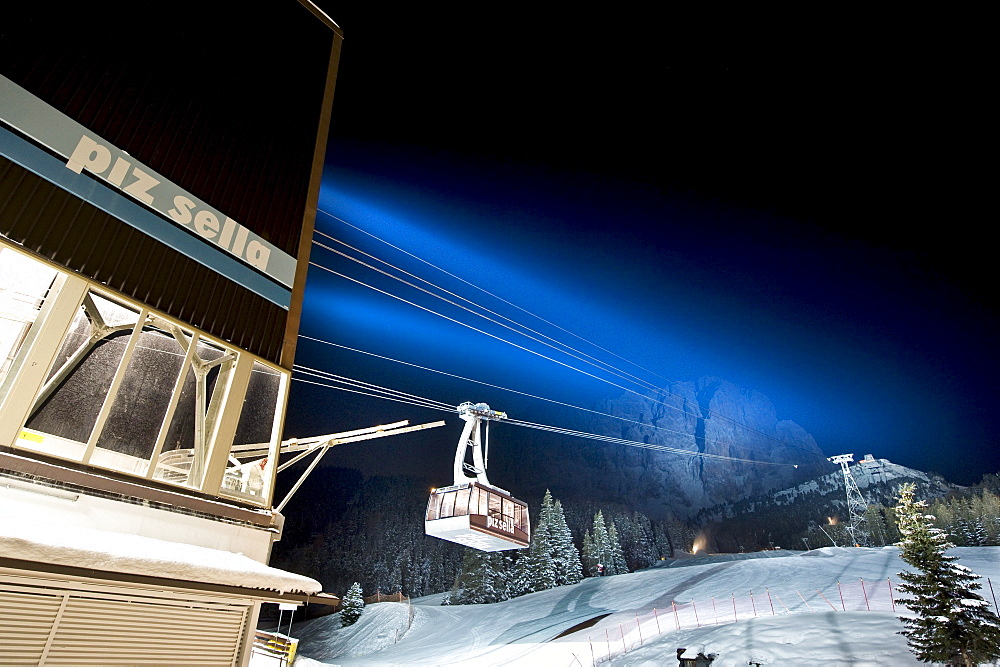 Illuminated cable car above ski slope at night, Sella, Alto Adige, South Tyrol, Italy, Europe