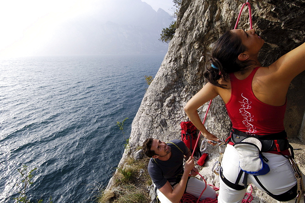 Two climbers at a rock face above lake Garda, Italy, Europe