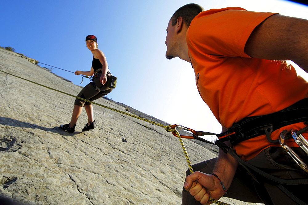 Two climbers at a rock face in the sunlight, Alto Adige, South Tyrol, Italy, Europe