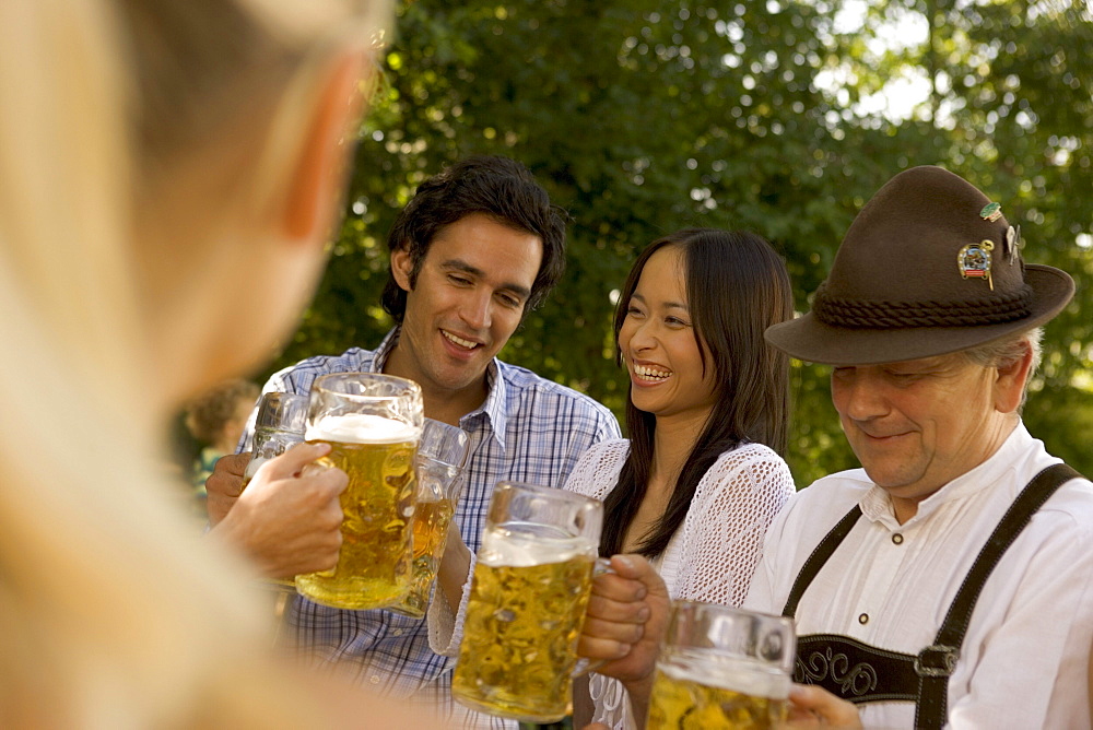 Friends toasting in beergarden, Bavaria, Germany