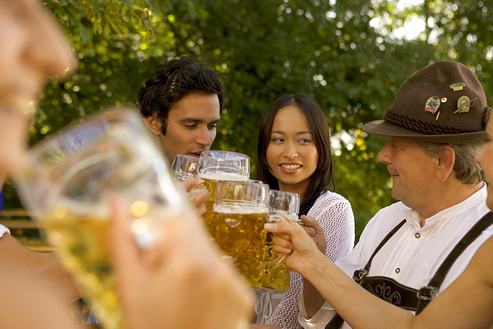 Friends toasting in beergarden, Bavaria, Germany