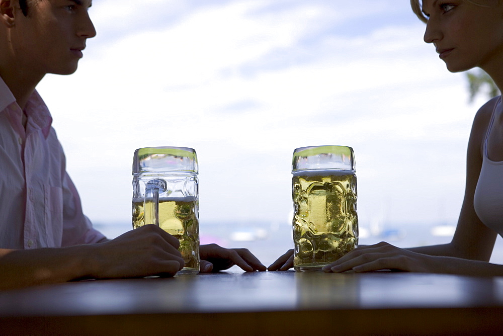 Two young adults in beergarden near Lake Starnberg, Bavaria, Germany