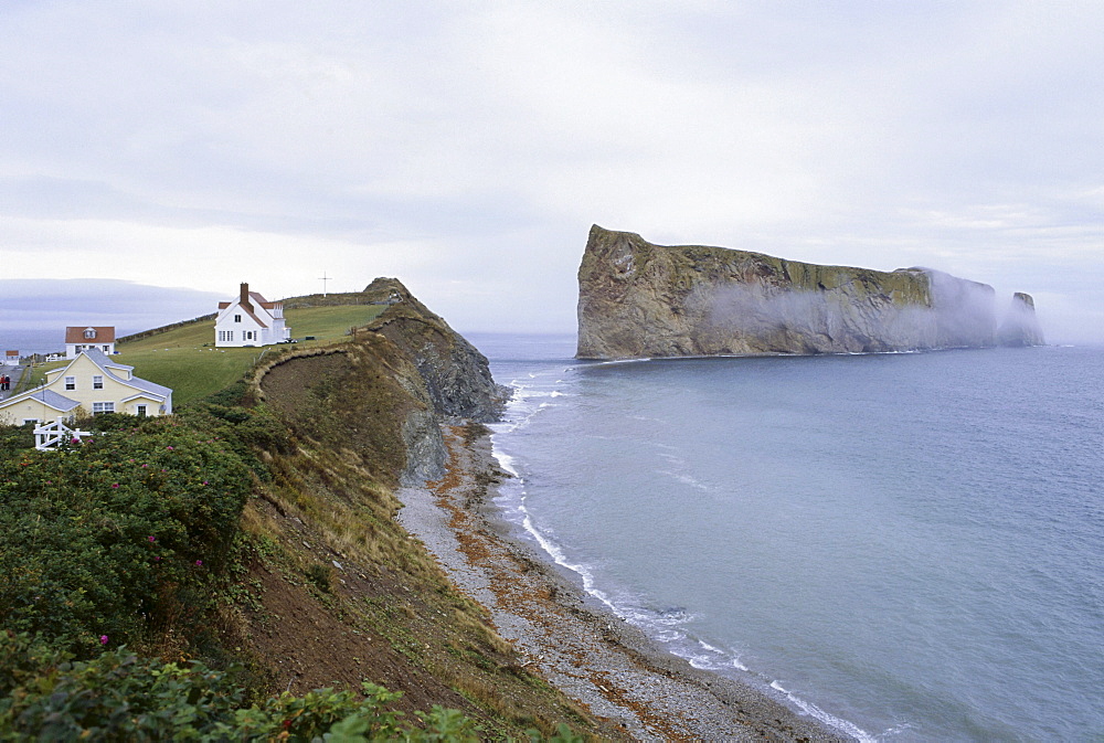 Houses at the coast under grey clouds, Perce Rock, Perce, Gaspesie, Quebec, Canada