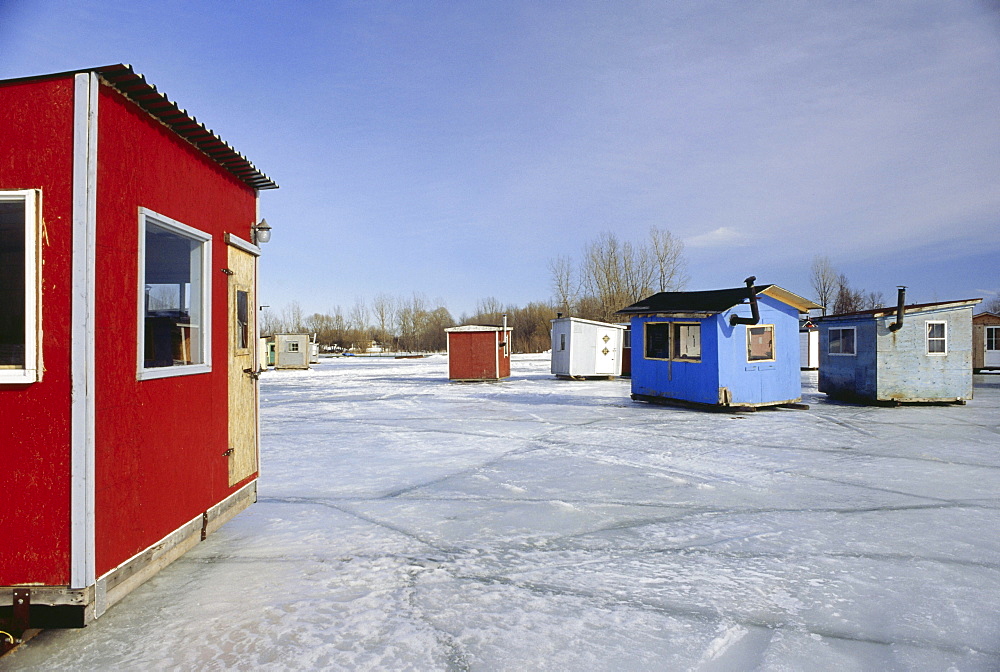 Ice fishing, cabins standing on frozen St. Lawrence River, Quebec, Canada