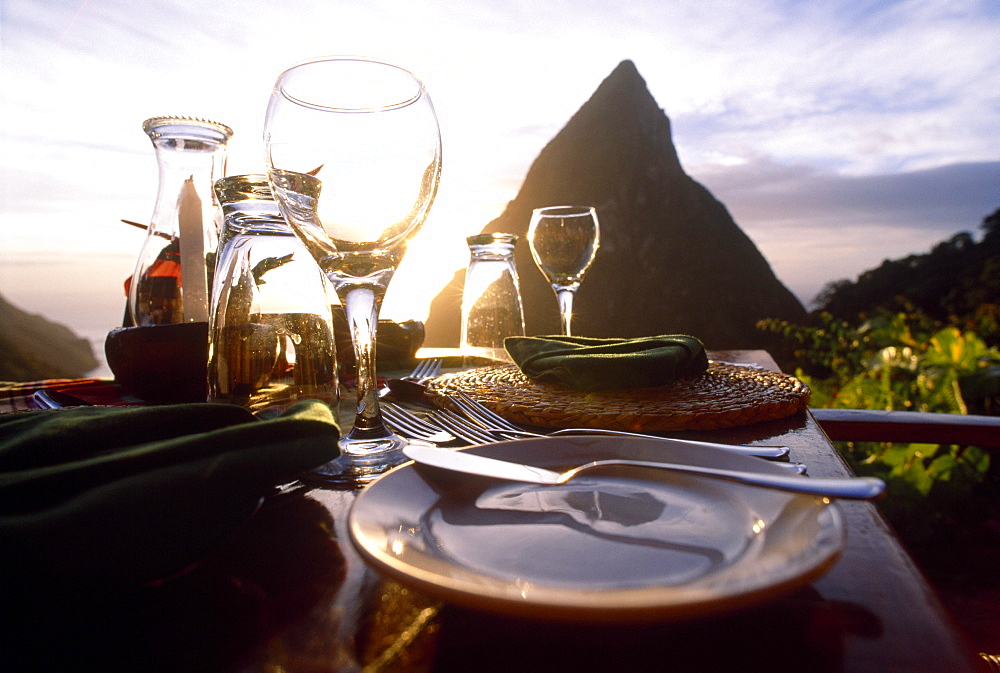 A table is laid on the terrace of the Restaurant Dasheene at sunset, Soufriere, St. Lucia, Carribean