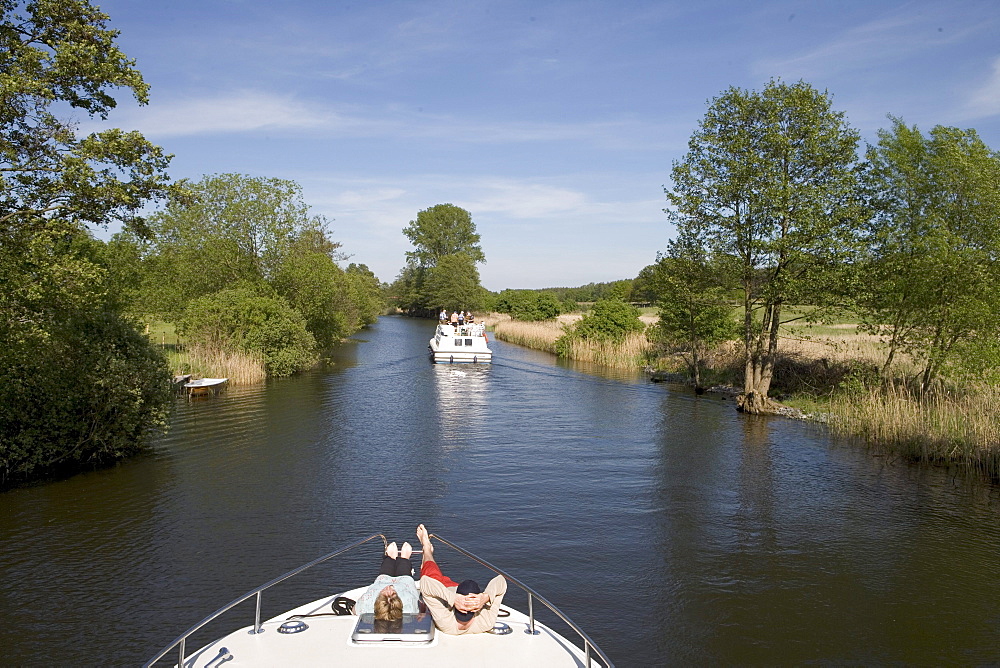 Relaxing on Houseboat Bow, Relaxing on houseboat bow, Crown Blue Line Grand Classique Houseboat, Huettenkanal Channel, Mecklenburgian Lake District, Germany