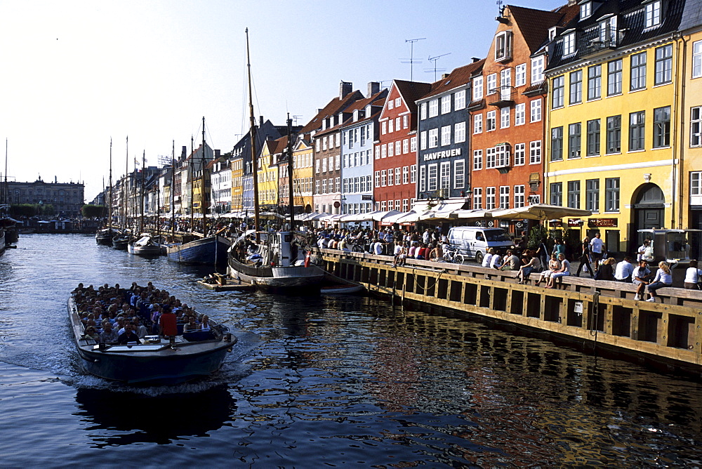 Nyhavn Sightseeing Boat, Old houses, boats and CafÃˆs along the Nyhavn Canal, Copenhagen, Denmark