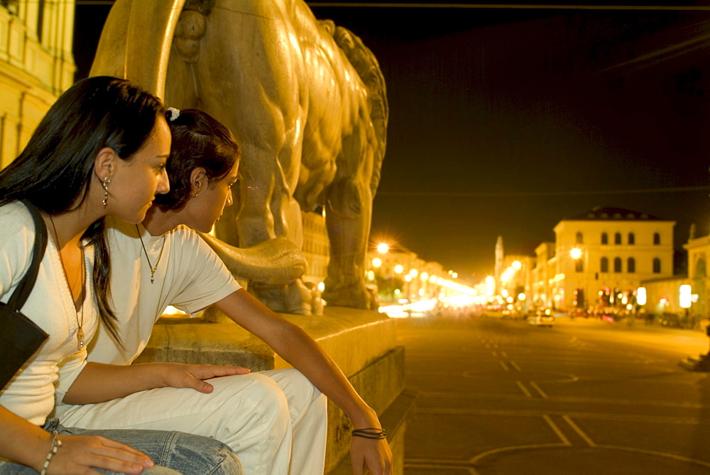 Couple at night, View from Feldherrnhalle to Ludwigstrasse, Odeonsplatz, Munich, Bavaria, Germany