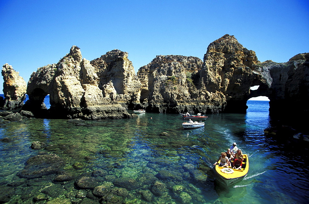 Boats in front of rock formation, Ponta da Piedade, Lagos, Algarve, Portugal, Europe