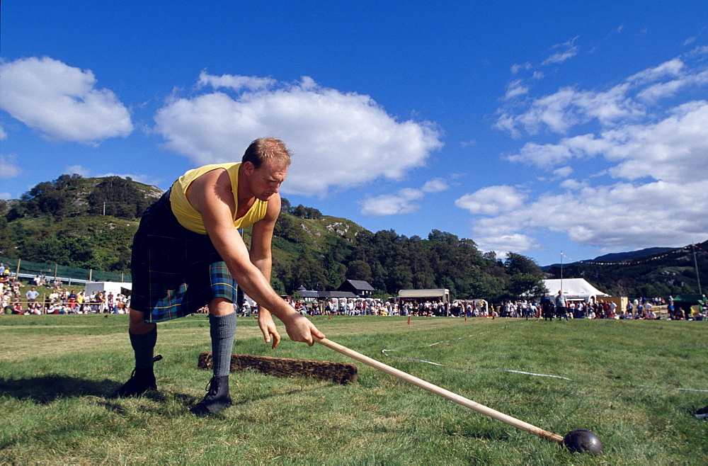 Man with kilt holding a sledge hammer, Glenfinnan Highland Games, Invernesshire, Scotland, Great Britain, Europe