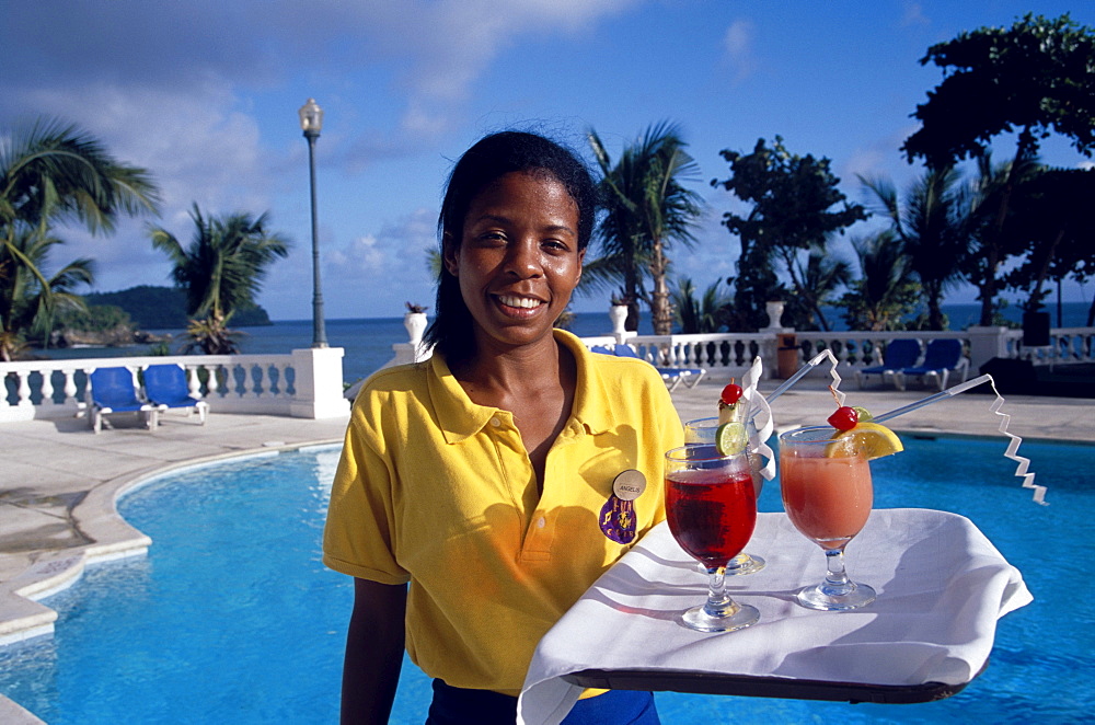 Waitress carrying cocktails at the pool of Hotel Gran Bahia, Samana, Samana Peninsula, Dominican Republic, Caribbean