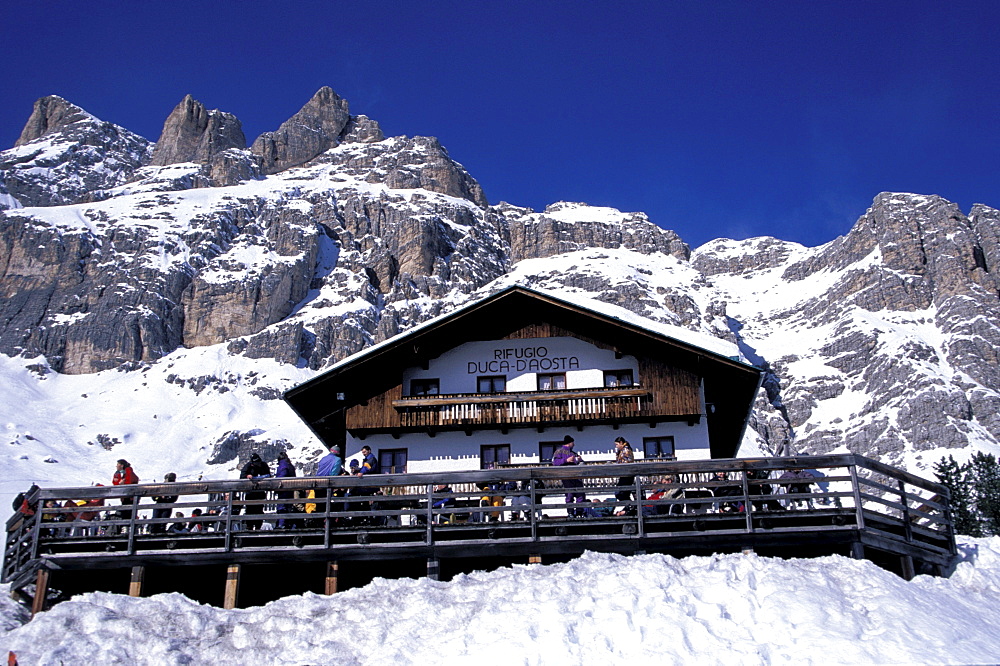 Low angle view of Duca dÂ¥Aosta hotel in front of snowy mountains, Tofana, Cortina dÂ¥Ampezzo, Dolomites, South Tyrol, Italy, Europe