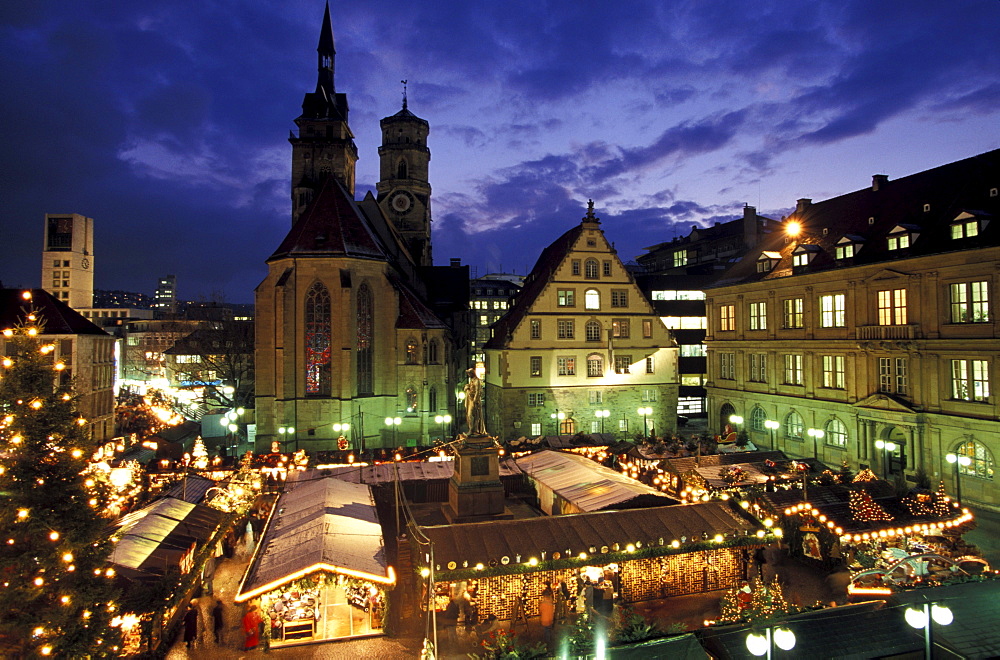 Christmas market on the Square Karlsplatz with church Stiftskirche and Schiller monument, Stuttgart, Germany