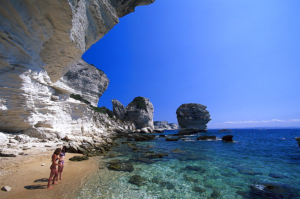 Two women at the beach, Plage de Sutta Rocca, cliffs of Bonifacio, Corsica, France