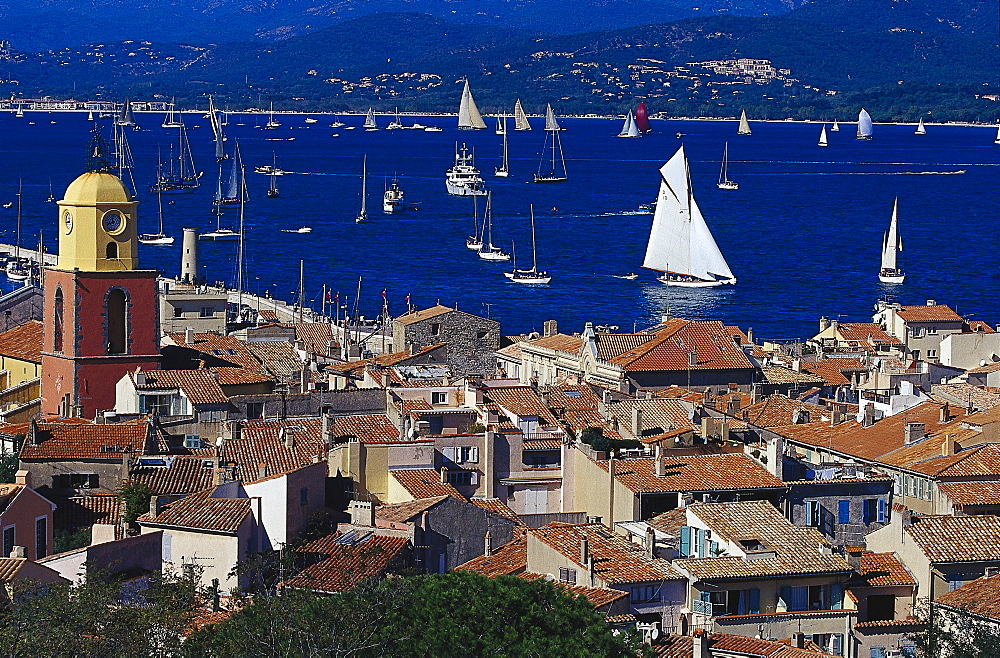 Sunlit roofs and sailing boats at Golfe de St.Tropez, St. Tropez, Cote dÂ¥Azur, Provence, France, Europe