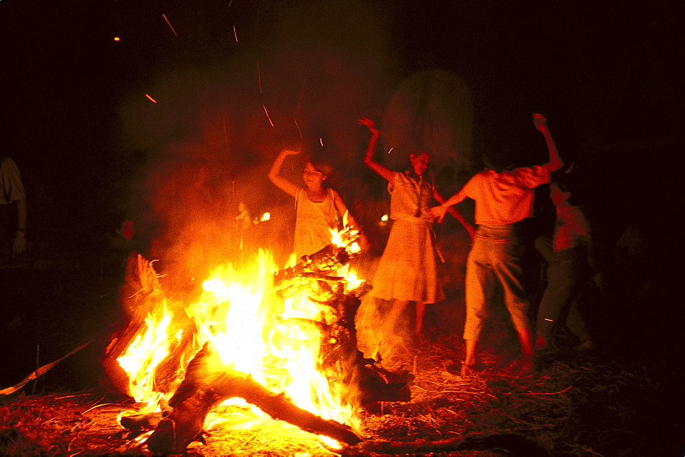 Young pilgrims dancing Sevillanas beside a campfire at night, RomerÃŒa al RocÃŒo, El RocÃŒo, pilgrimage, Andalusia, Spain